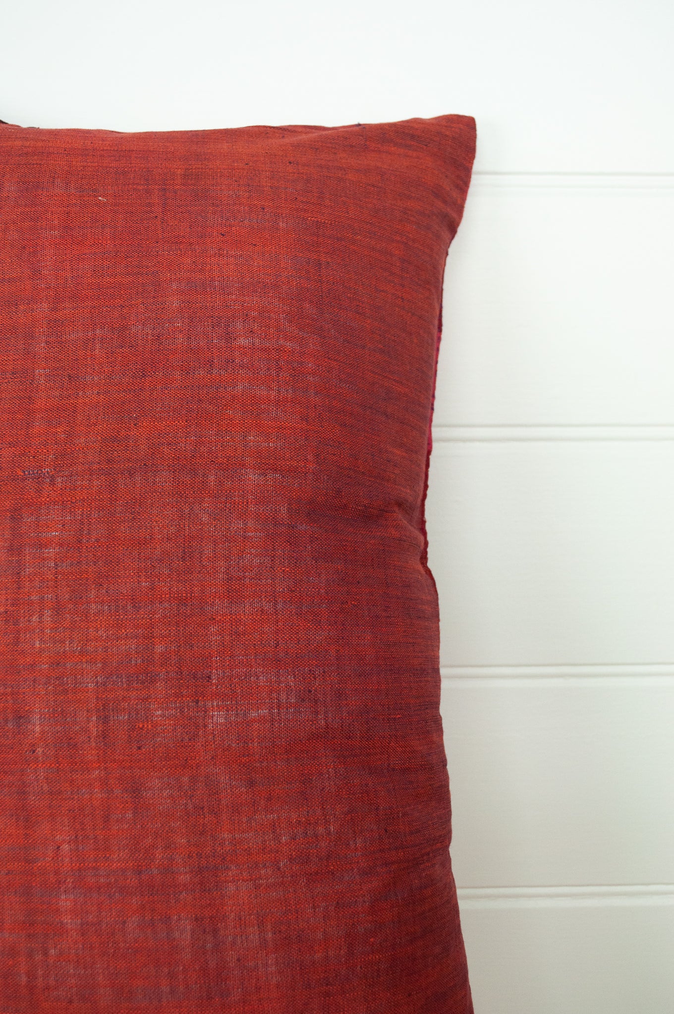 Vintage silk patchwork kantha bolster cushion is in rich tones of rose pink and red, with a dash of magenta (showing cotton backing fabric).