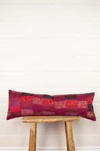 Load image into Gallery viewer, Vintage silk patchwork kantha bolster cushion 20x60cm is in shades of magenta, deep rose pink, and red.