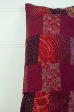 Load image into Gallery viewer, Vintage silk patchwork kantha bolster cushion 20x60cm is in shades of magenta, deep rose pink, and red.