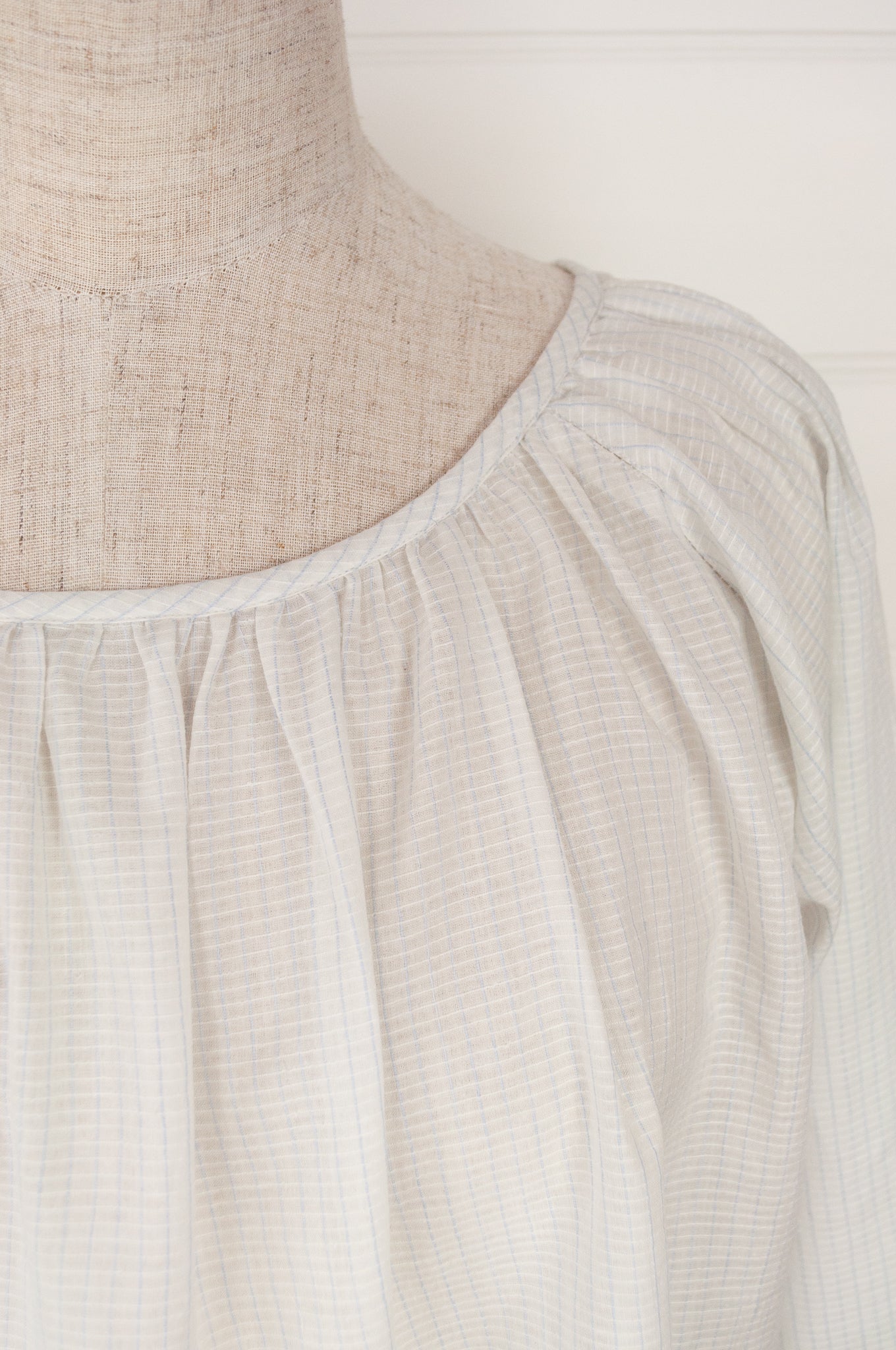 Juniper Hearth Yuka top in fine white cotton with self check, fine black stripe border with lavender highlight, gathered neck, loose fit one size long sleeve smock tunic top.