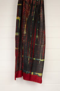 Neeru Kumar fine wool shibori dyed scarf in red black and yellow with highlights of blue.