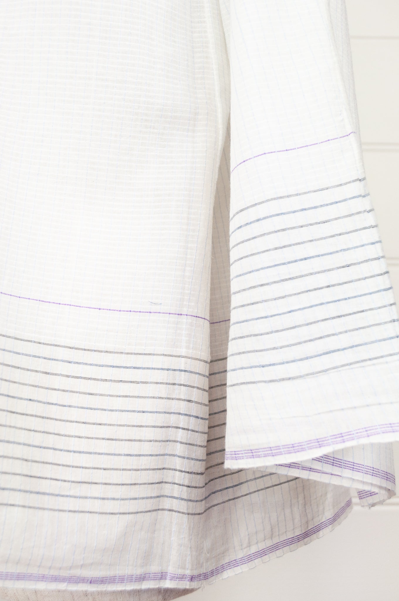 Juniper Hearth Yuka top in fine white cotton with self check, fine black stripe border with lavender highlight, gathered neck, loose fit one size long sleeve smock tunic top.