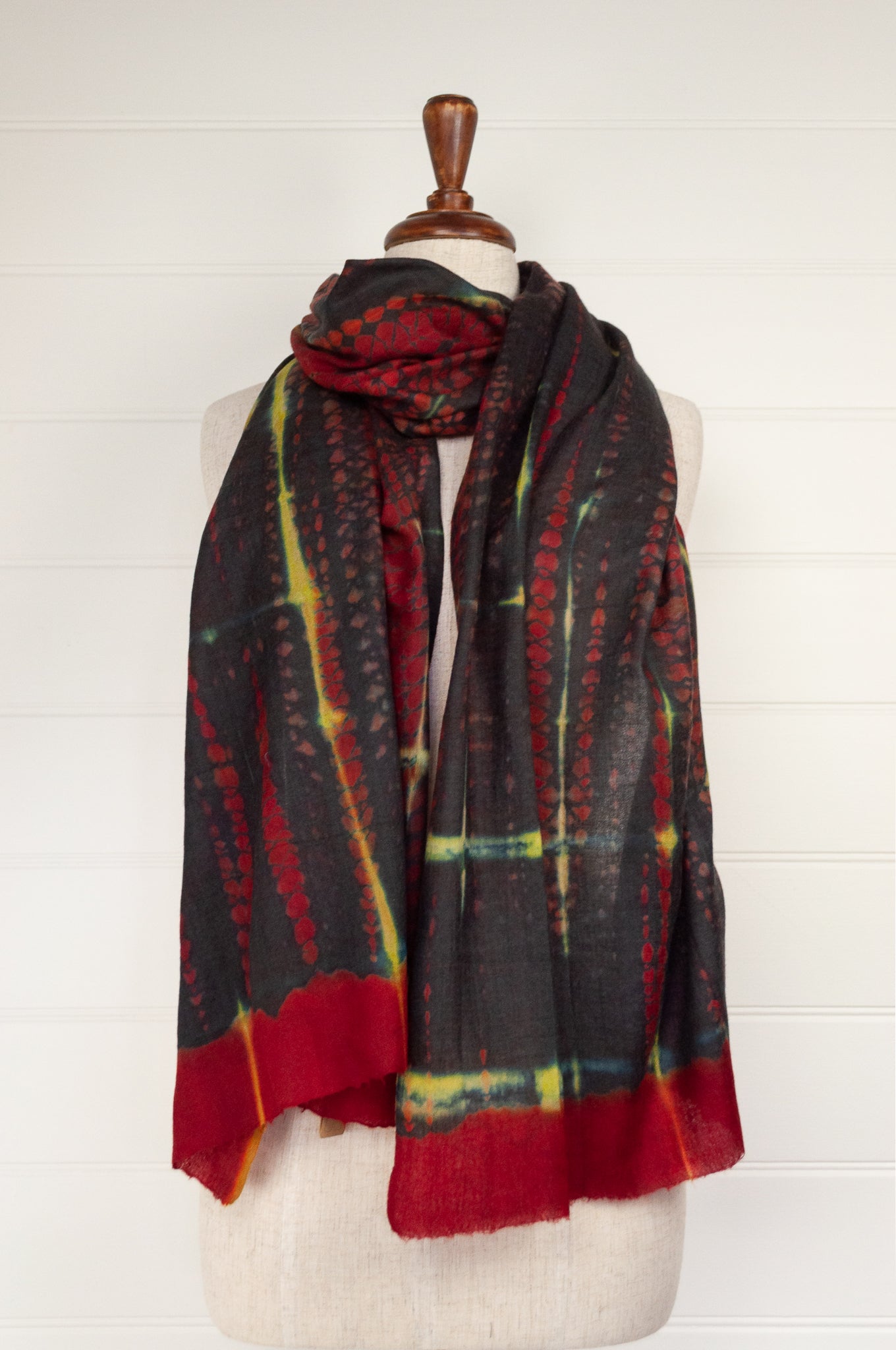 Neeru Kumar fine wool shibori dyed scarf in red black and yellow with highlights of blue.