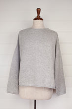 Load image into Gallery viewer, Juniper Hearth ash grey marle reversible one size cashmere cardigan, roll neck edges to neck, sleeves and hem, shell buttons, can be worn as a cardigan or reversed as a sweater.