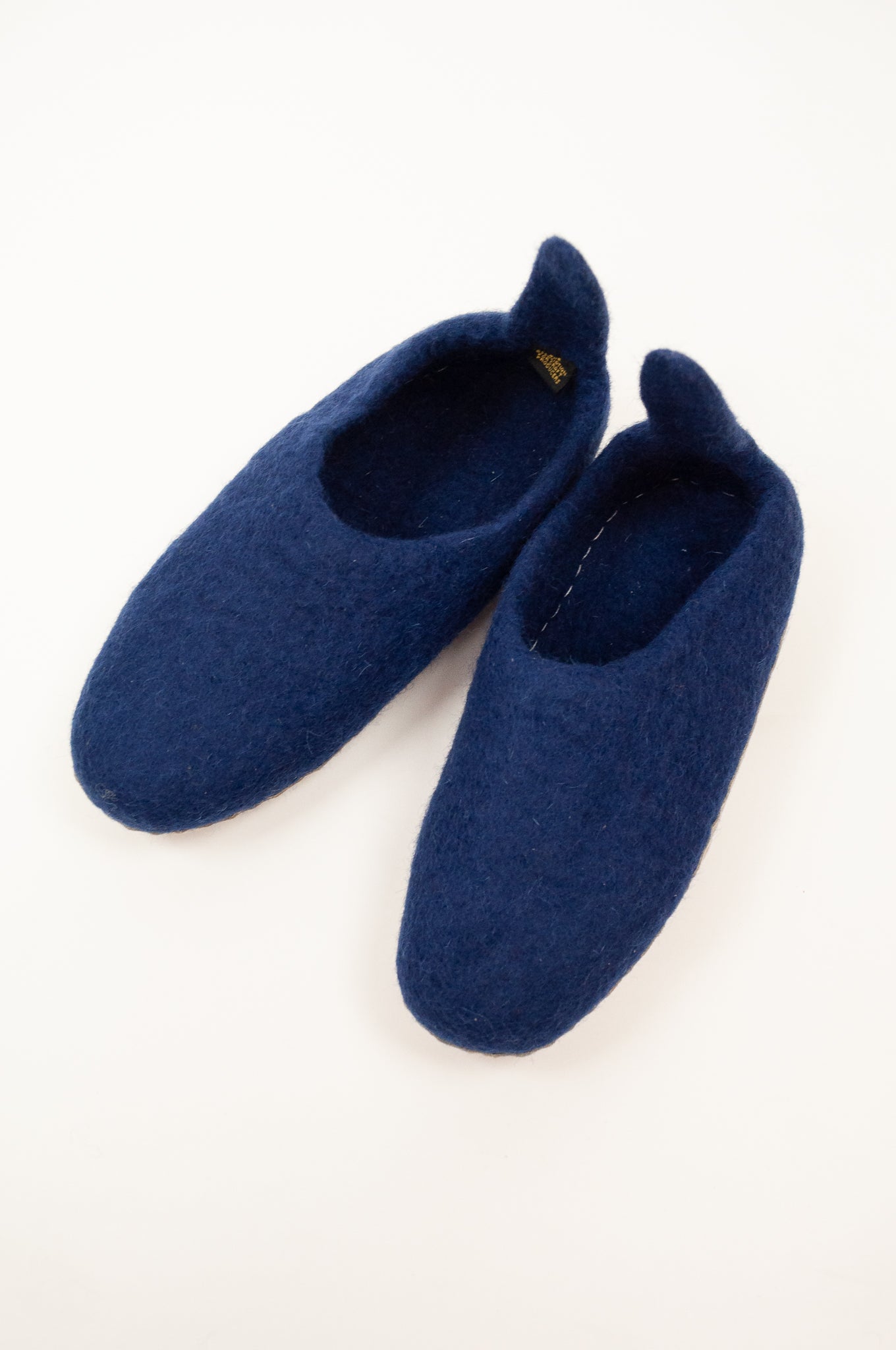 Navy blue wool felt slippers, pull on style with tab, fair trade and ethically made in Nepal.