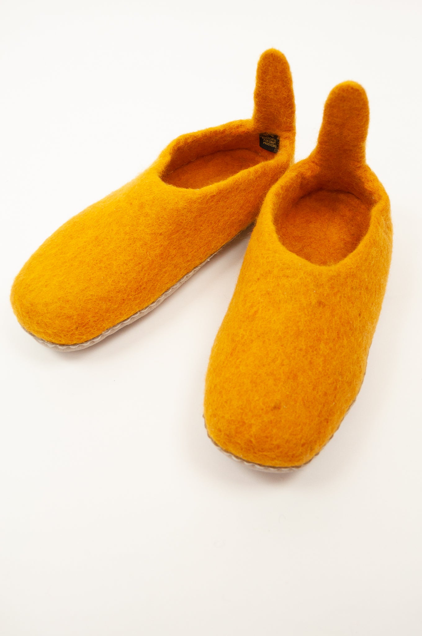 Mustard yellow wool felt slippers, pull on style with tab, fair trade and ethically made in Nepal.