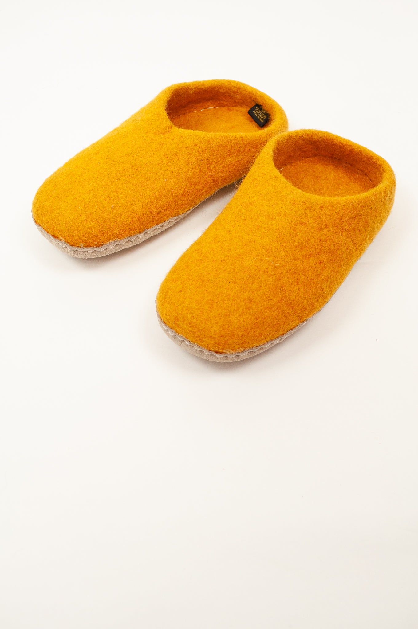 Mustard yellow wool felt slippers, slip on style, fair trade and ethically made in Nepal.