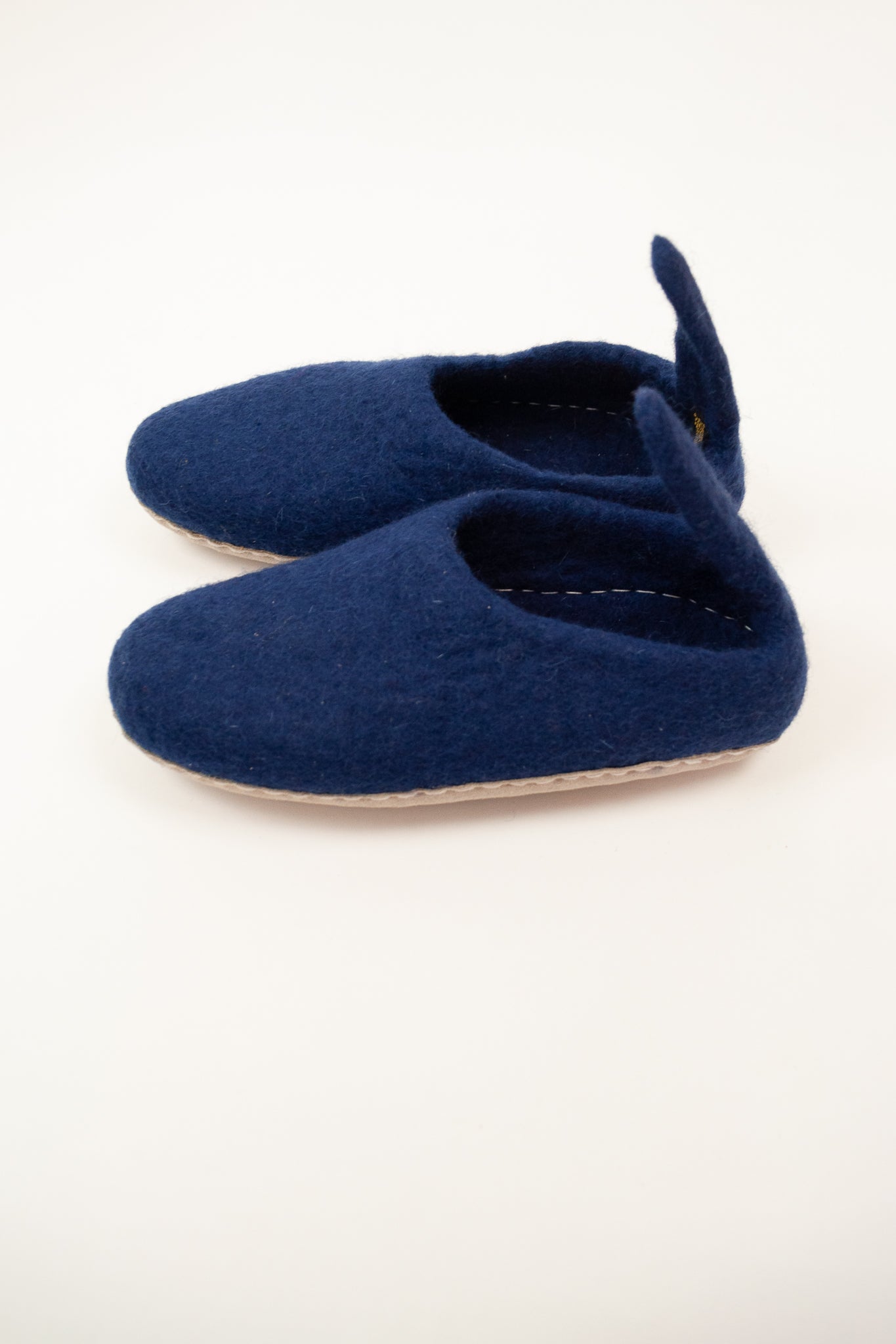 Navy blue wool felt slippers, pull on style with tab, fair trade and ethically made in Nepal.