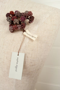 Sophie Digard TINYV2 wool embroidered flower brooch in chocolate, pink,grey and red tones.