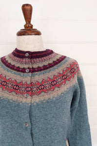 Eribe Alpine short fair isle cardigan in Old Rose,nostalgic palette of dusky aqua with accents of burgundy and oatmeal, and pops of cheerful rose pink.