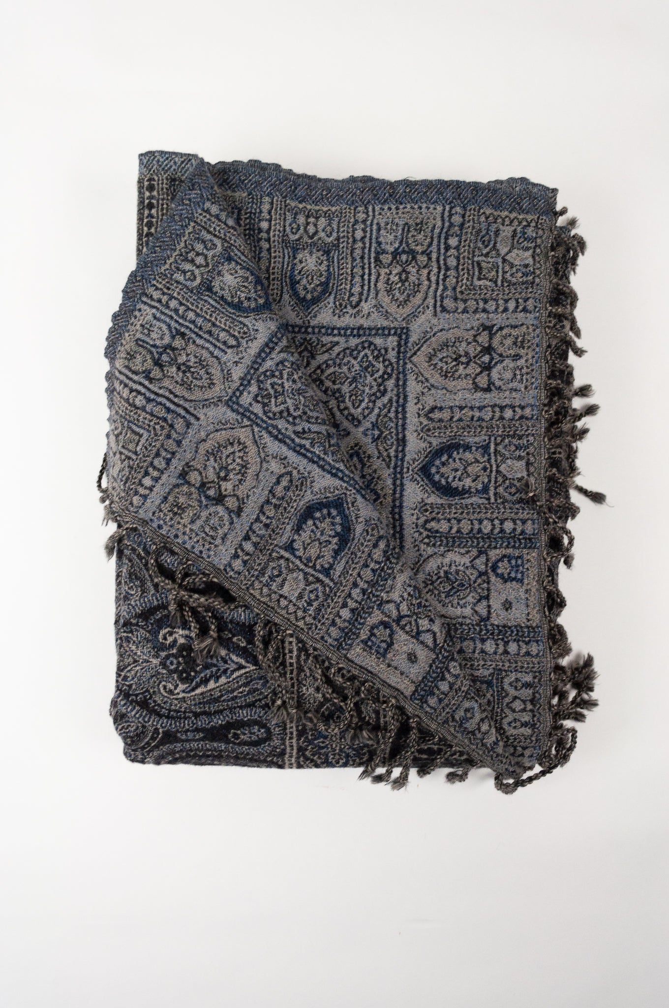Juniper Hearth pure wool tasseled reversible throw in denim blue, indigo and charcoal grey paisley.