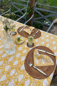 Cotton table napkins, blockprinted by hand exclusively for Juniper Hearth, Sara floral in white on honey yellow.