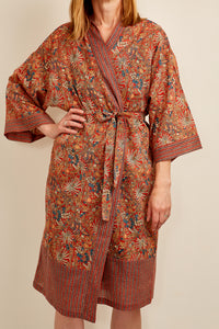 Cotton voile kimono robe dressing gown in a rust red palm print with red and blue matching geometric trim.