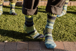 Solmate recycled cotton mismatched Lemongrass socks in dark gray, lime green, navy blue, and cobalt teal.