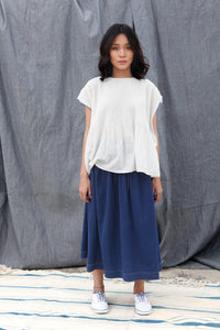 DVE Collection Adya one size top in white jamdani cotton, pin tucking at front, smock panel at back, loose fitting with cap sleeves and selvedge detailing to sides in blue.