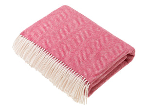 Bronte by Moon Herringbone throw in cerise pink merino wool. Made in England.